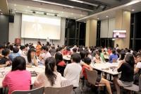 College students attending a communal dinner talk